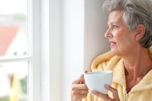 Active senior woman in the morning with a cup of coffee