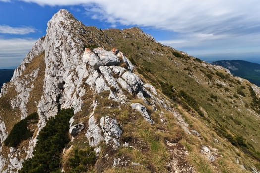 a mountain top and clouds in a blue sky, Piatra Craiului Mountains, Romania