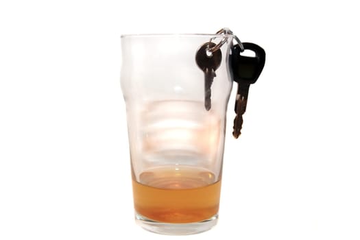pint beer glass with car keys inside glass on white background depicting drunk driving and addictions can kill