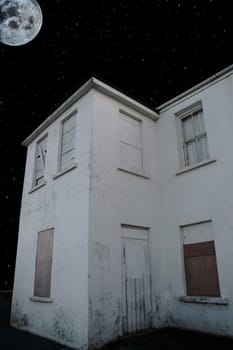 an old abandoned facade lit up in the moonlight