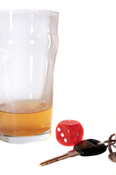 dice and beer glass with car keys on white background depicting gambling with drunk driving and addictions can kill