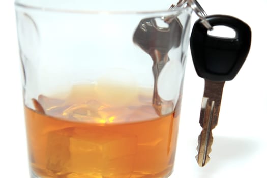 bourbon with keys inside glass on white background depicting drunk driving and addictions can kill