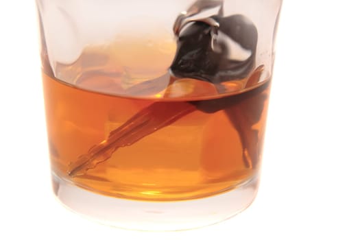 whiskey with keys inside glass on white background depicting drunk driving and addictions can kill