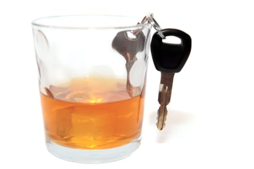 bourbon with keys inside glass on white background depicting drunk driving and addictions can kill