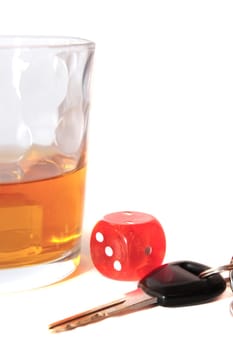 dice and whiskey glass with car keys on white background depicting gambling with drunk driving and addictions can kill