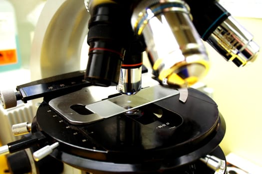 Close up of microscope lenses focused on a specimen