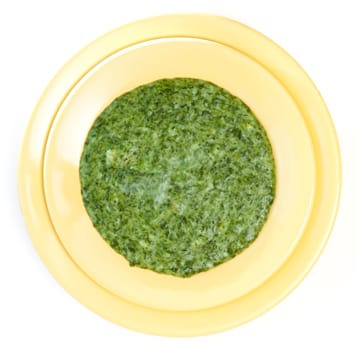 Spinach cream soup in yellow plate