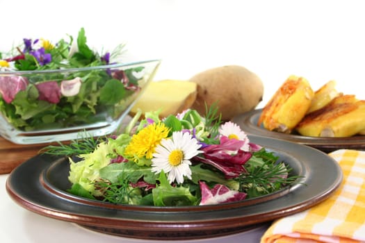 Wild herb salad with goat's cheese baked in a potato coat