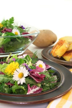 Wild herb salad with goat's cheese baked in a potato coat