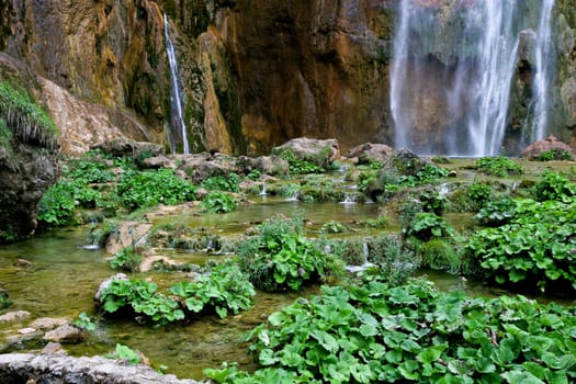 a small waterfall on a mountain slope