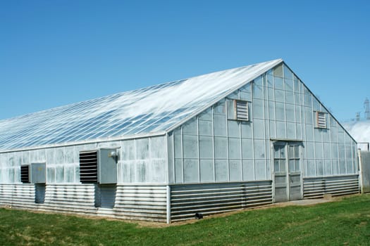 A green house with blue sky