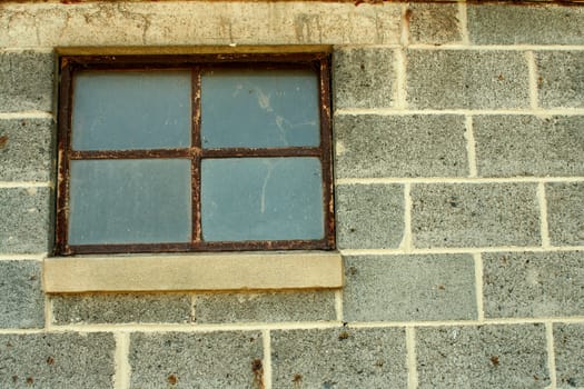 A Concrete block wall with window