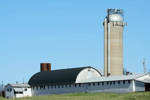 A Barn and silo with blue sky