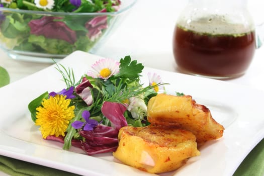 Wild herb salad with goat's cheese baked in a potato coat