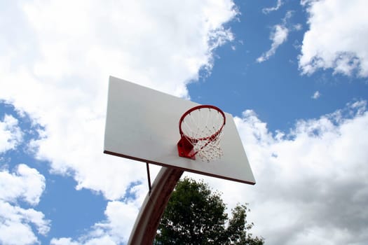 an image of a Basketball hoop against a cloudy sky