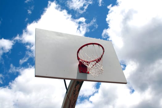 an image of a Basketball hoop against a cloudy sky