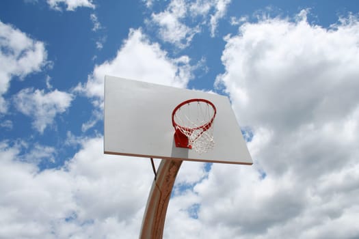 an image of a Basketball hoop against a cloudy sky