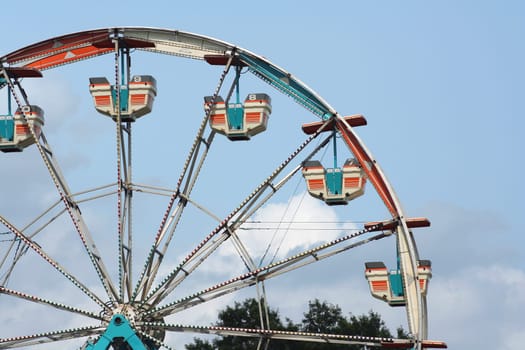 Ferris wheel against bule sky with clouds
