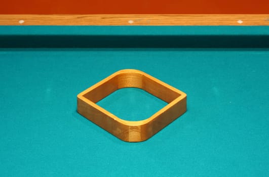 Empty 9 ball rack on a pool table