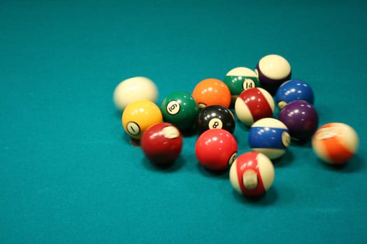 8 ball being broken on green pool table
