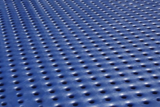 a Blue metal background with holes