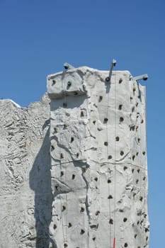 A Rock Climbing Wall against a blue sky
