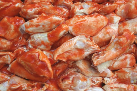 Uncooked Chicken Wings covered in sause