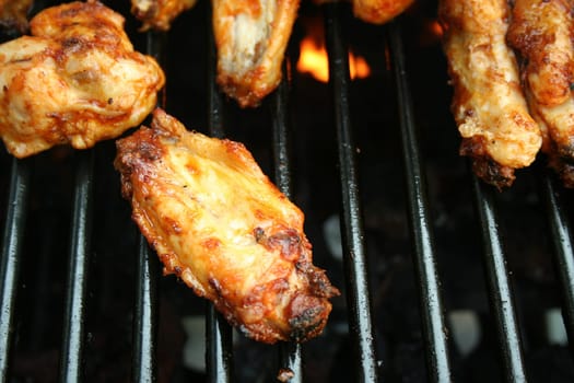 Chicken Wings Cooking on the grill covered in sause