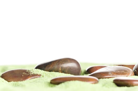 Brown stones messed up on green sand