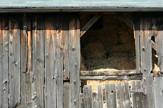 An Old wooden barn with bails of hay