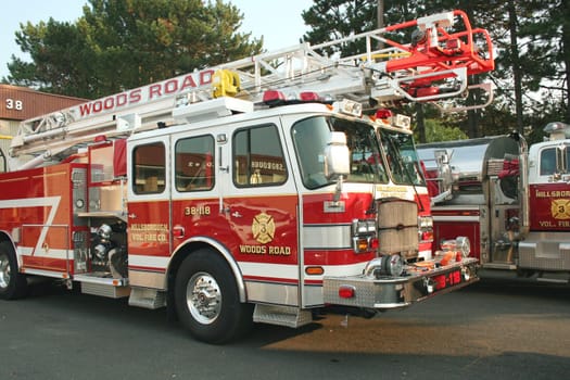 A Fire Truck parked outside a firehouse