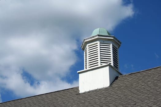 A Building peak crowsnest against blue sky
