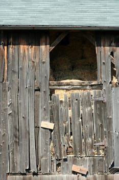 An Old wooden barn with bails of hay