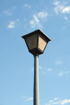 Lamppost against a blue cloudy sky