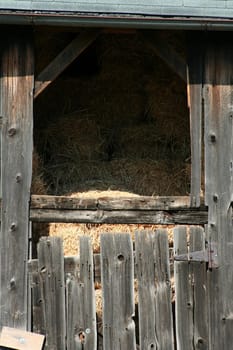 An Old wooden barn with bails of hay