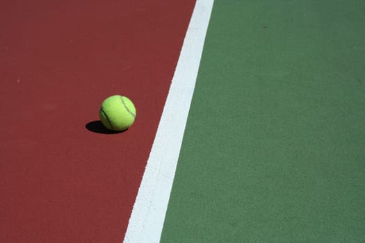 A Tennis Ball out of bounds with white line