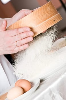 Flour sifting through a sieve for a baking