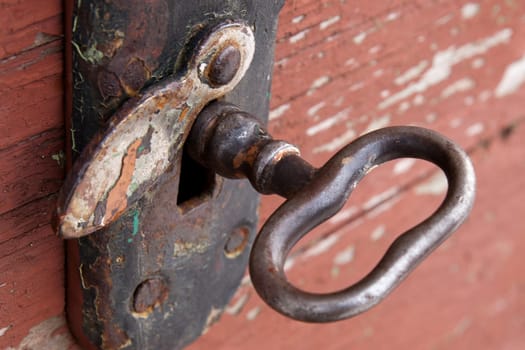 Old key in a rusted  door lock