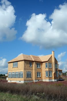 A New House being constructed under a blue sky