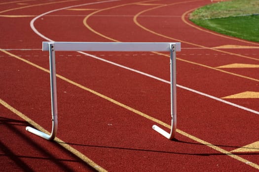 A hurdle on a red running track