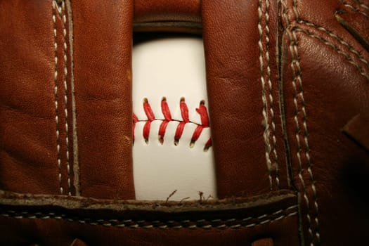 A close up of a Baseball in a glove