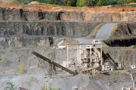 A Rock Quarry with equipment and road