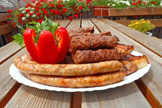 Prepared meat from the grill, ready for eating, with red pepper