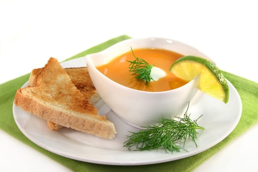 a bowl of salmon cream soup with cream and dill