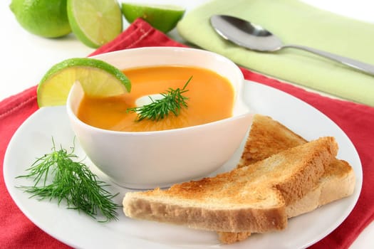 a bowl of salmon cream soup with cream and dill