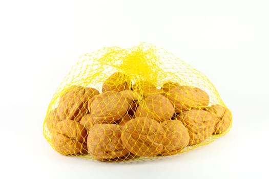 Walnuts in a plastic net isolated on white