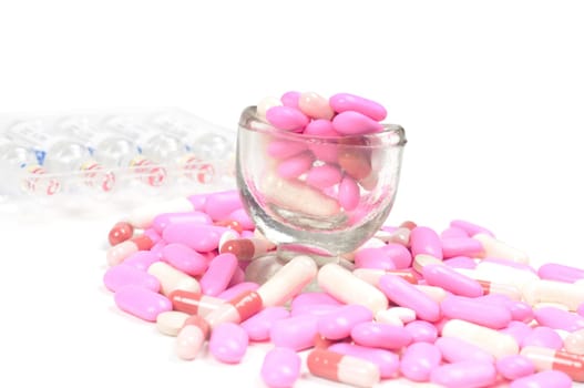 Shot of pink drugs (tablets) isolated on white