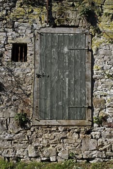 Wall with wooden door and window