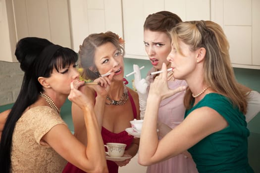 Unsure young woman around older ladies smoking in the kitchen