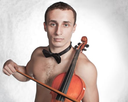 handsome guy shirtless with bow tie having fun with violin (low saturation toning)